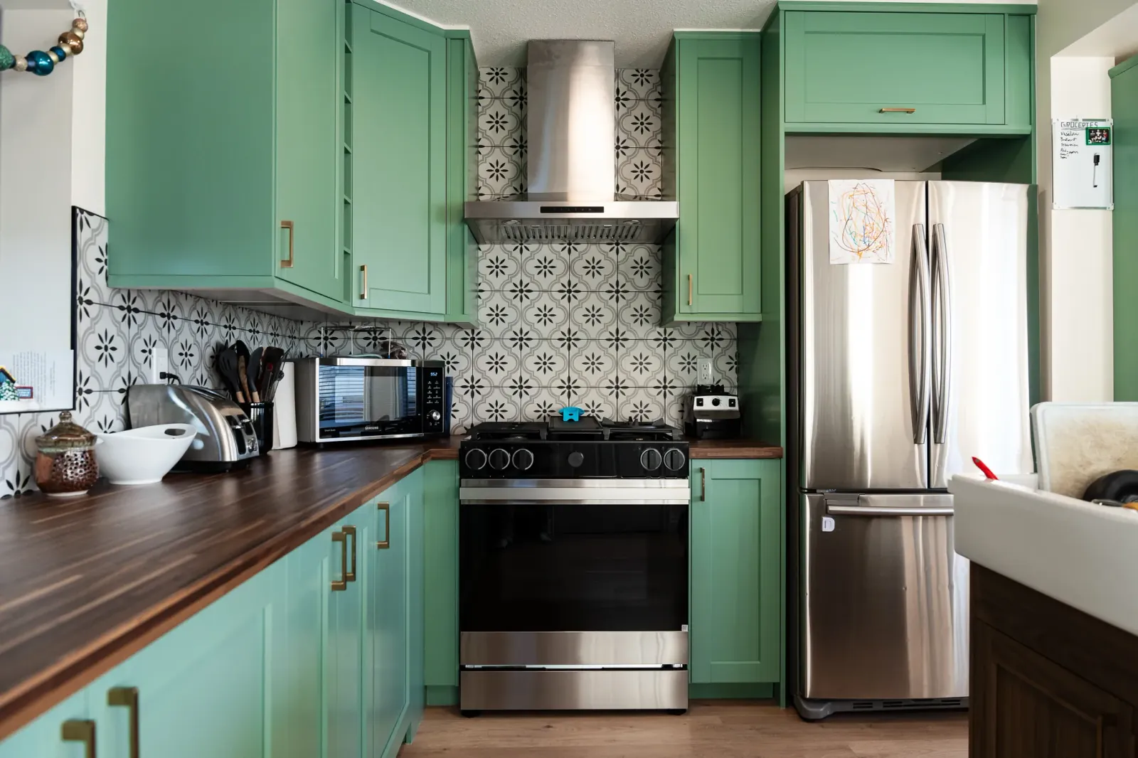 Calgary kitchen reno with sage green custom cabinets