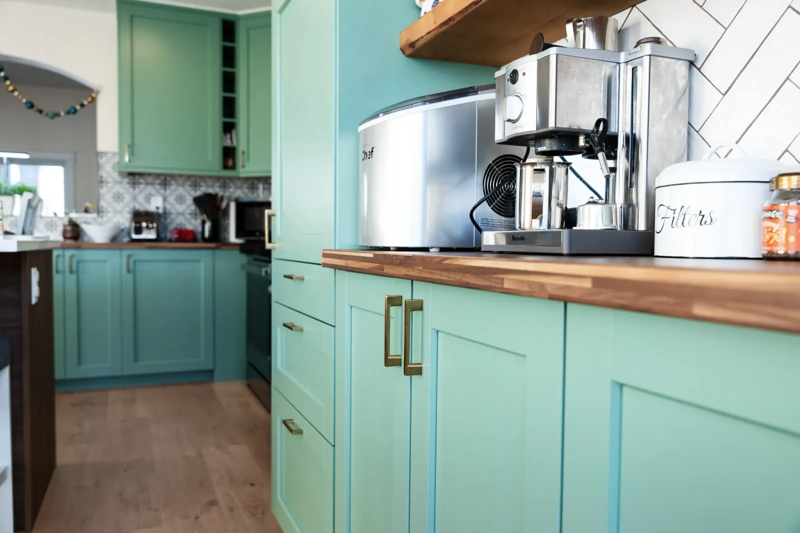 bar area with a butcher block countertop and green cabinets in a Calgary kitchen reno