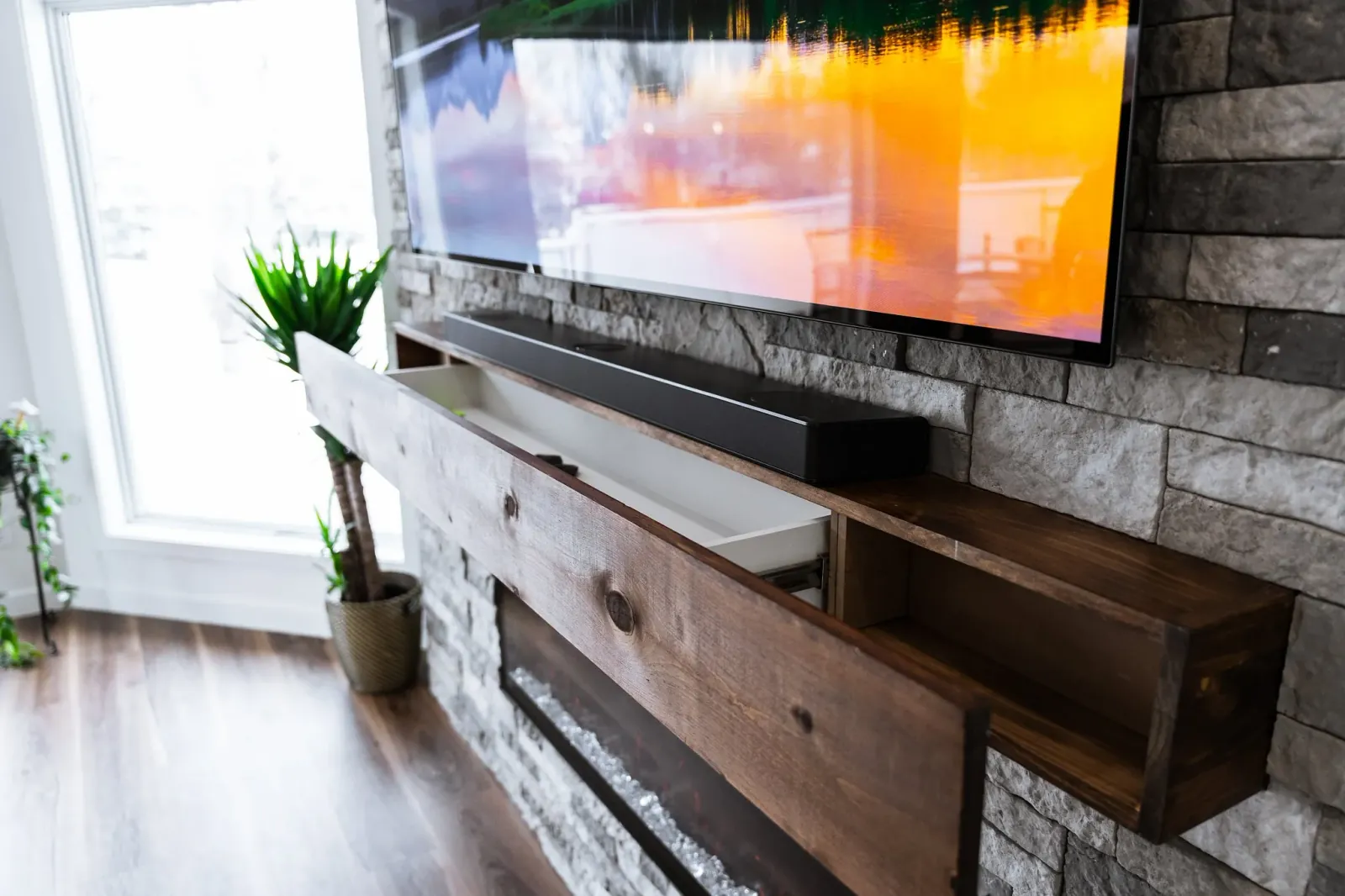 Custom solid wood mantel piece with a hidden drawer in a complete home renovation in Calgary