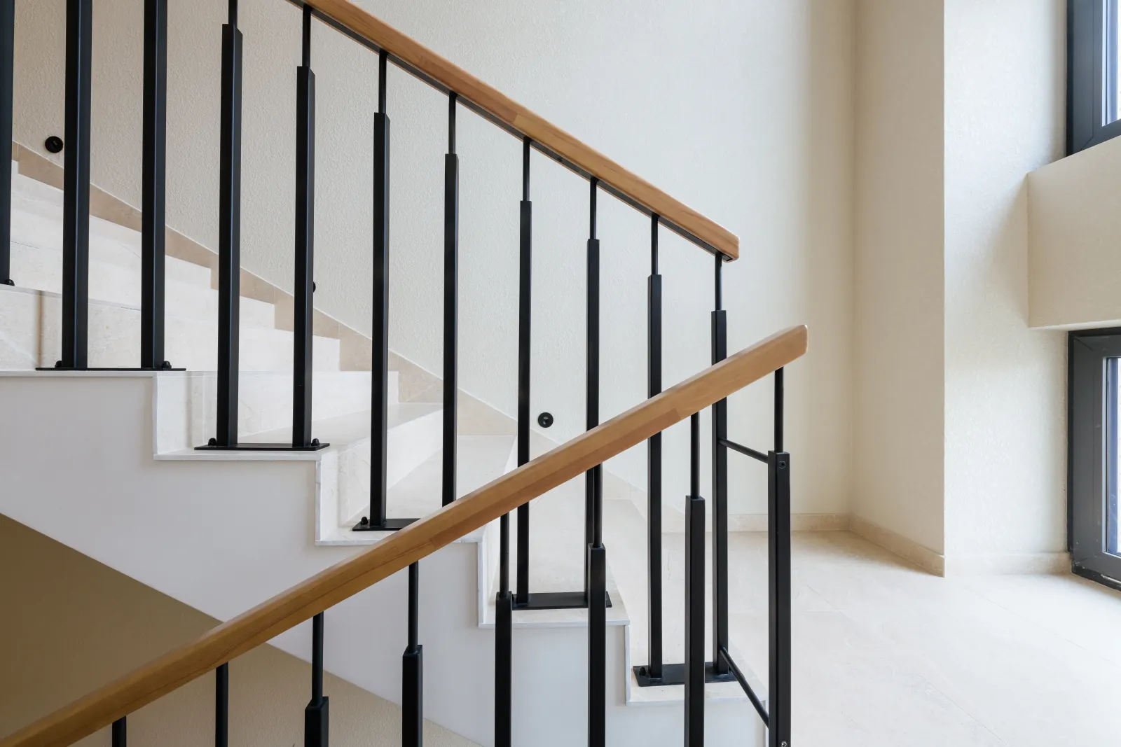 Combination of metal spindles and a wood handrail in a Calgary home reno